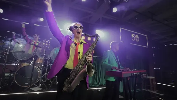 Саксофонист Стиляги BAND в фиолетовом пиджаке на сцене